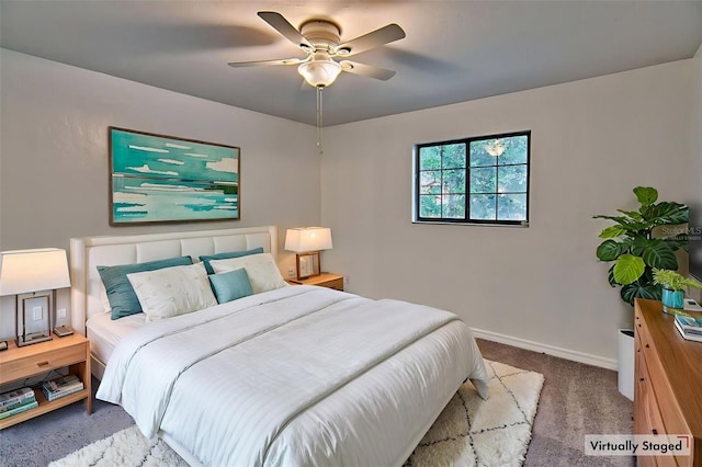carpeted bedroom featuring baseboards and a ceiling fan