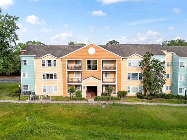 2601 SW Archer Rd Unit G 128, Gainesville, FL 32608 - view of front of house featuring cooling unit and a front lawn