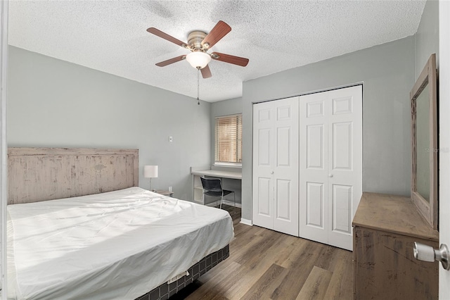2601 SW Archer Rd Unit G 128, Gainesville, FL 32608 - bedroom featuring a textured ceiling, wood finished floors, a closet, and ceiling fan
