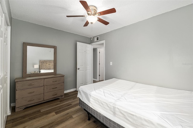 2601 SW Archer Rd Unit G 128, Gainesville, FL 32608 - bedroom featuring wood finished floors, a textured ceiling, a ceiling fan, and baseboards