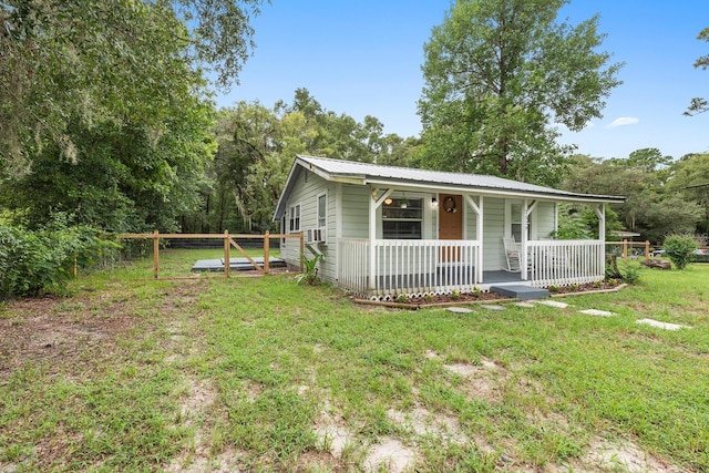 2529 SE 11th Ave, Gainesville, FL 32641 - view of front of home featuring covered porch, metal roof, and cooling unit