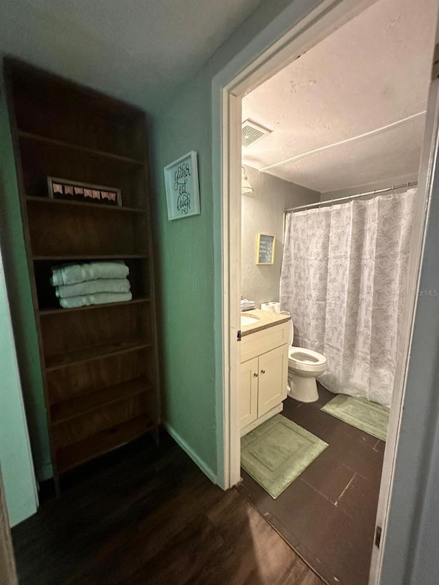 2529 SE 11th Ave, Gainesville, FL 32641 - full bathroom featuring wood finished floors, toilet, vanity, and a shower with shower curtain