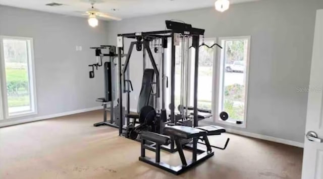 exercise area featuring healthy amount of natural light, baseboards, and ceiling fan