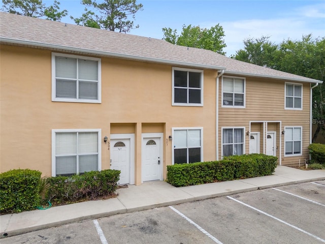 4415 SW 34th St Unit 503, Gainesville, FL 32608 - townhome / multi-family property with uncovered parking, stucco siding, and a shingled roof