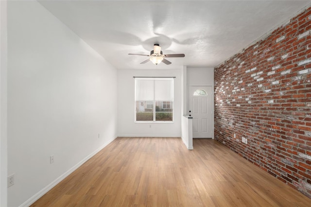 4415 SW 34th St Unit 503, Gainesville, FL 32608 - spare room with brick wall, ceiling fan, light wood finished floors, and baseboards