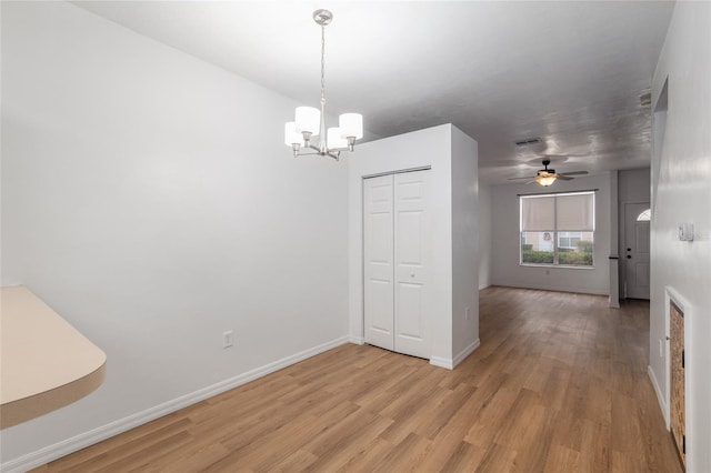 4415 SW 34th St Unit 503, Gainesville, FL 32608 - unfurnished dining area featuring light wood-style floors, a chandelier, baseboards, and a ceiling fan