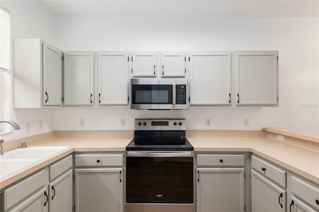 4415 SW 34th St Unit 503, Gainesville, FL 32608 - kitchen with stainless steel appliances, light countertops, and a sink