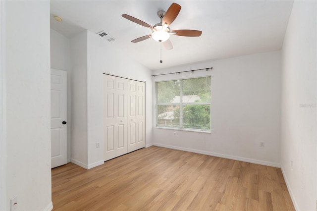 4415 SW 34th St Unit 503, Gainesville, FL 32608 - unfurnished bedroom featuring light wood-style flooring, baseboards, a closet, ceiling fan, and vaulted ceiling