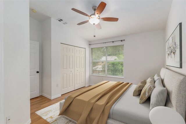 4415 SW 34th St Unit 503, Gainesville, FL 32608 - bedroom featuring light wood-style floors, a closet, baseboards, ceiling fan, and vaulted ceiling