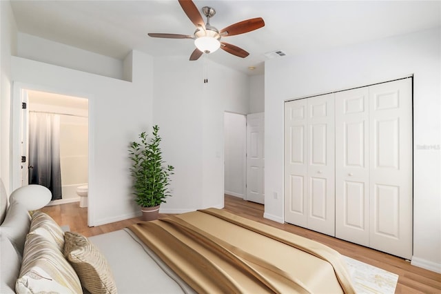 4415 SW 34th St Unit 503, Gainesville, FL 32608 - bedroom featuring light wood finished floors, a closet, baseboards, ensuite bathroom, and ceiling fan
