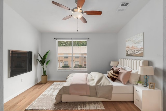 4415 SW 34th St Unit 503, Gainesville, FL 32608 - bedroom with wood finished floors, a ceiling fan, and baseboards