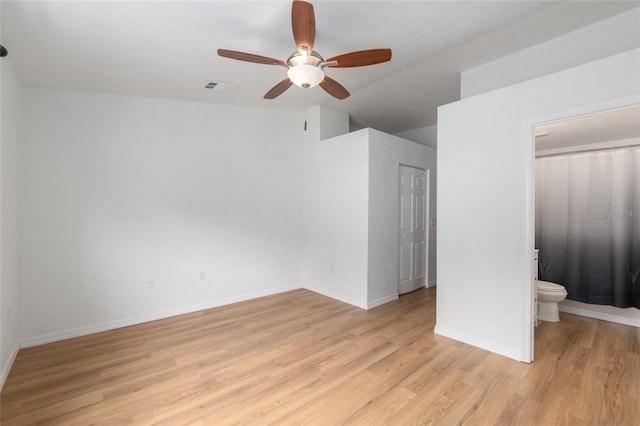 4415 SW 34th St Unit 503, Gainesville, FL 32608 - unfurnished bedroom with light wood-style floors, baseboards, ensuite bath, and ceiling fan