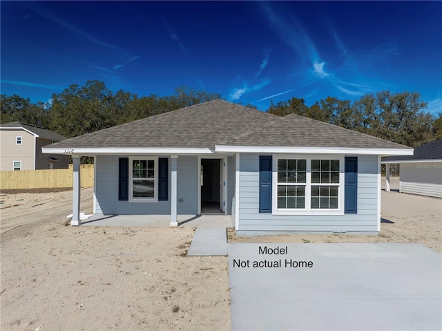 1926 N Roberts Trl, Bell, FL 32619 - view of front of property with covered porch, a shingled roof, and fence