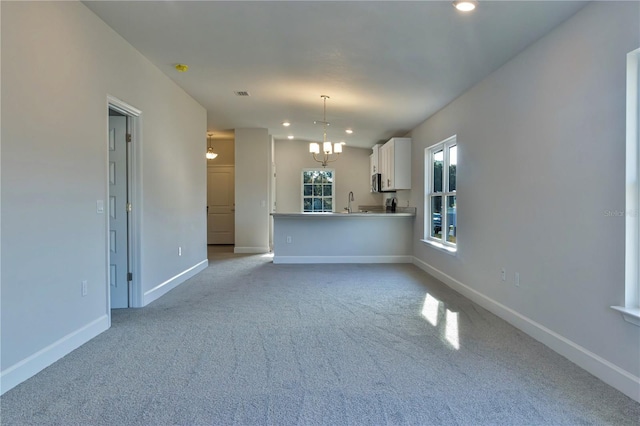 1926 N Roberts Trl, Bell, FL 32619 - unfurnished living room with a chandelier, carpet floors, baseboards, recessed lighting, and a sink