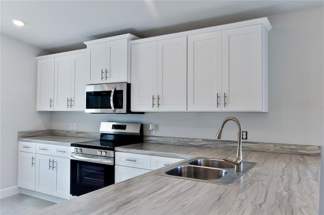 1926 N Roberts Trl, Bell, FL 32619 - kitchen featuring stainless steel appliances, a sink, white cabinetry, recessed lighting, and light stone counters