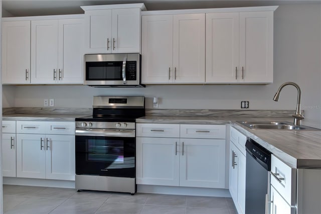 1926 N Roberts Trl, Bell, FL 32619 - kitchen featuring appliances with stainless steel finishes, a sink, white cabinets, and light tile patterned floors
