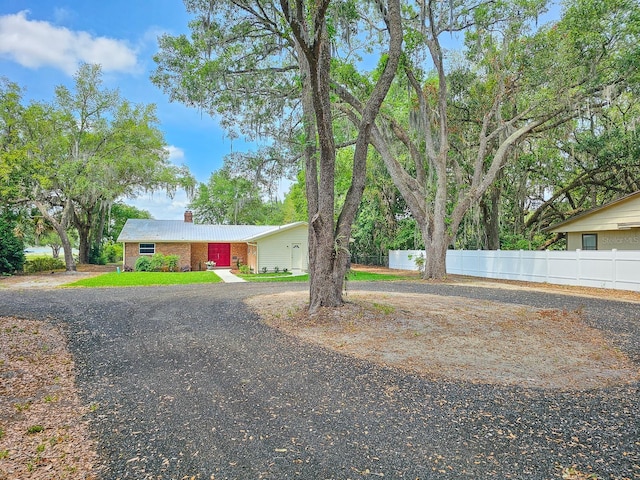 7972 State Rd Unit 100, Keystone Heights, FL 32656 - view of front of house featuring a chimney, fence, and curved driveway