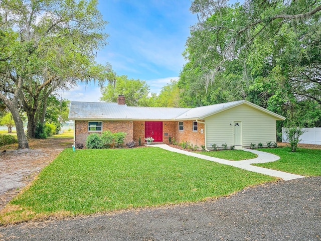 7972 State Rd Unit 100, Keystone Heights, FL 32656 - single story home with a chimney, brick siding, and metal roof