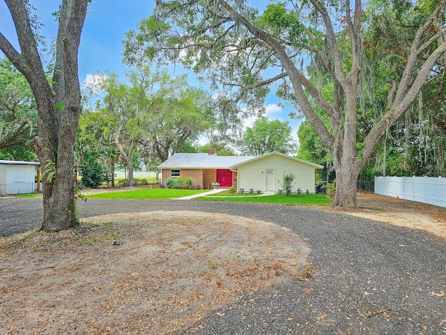 7972 State Rd Unit 100, Keystone Heights, FL 32656 - view of front of property featuring a chimney, curved driveway, and fence