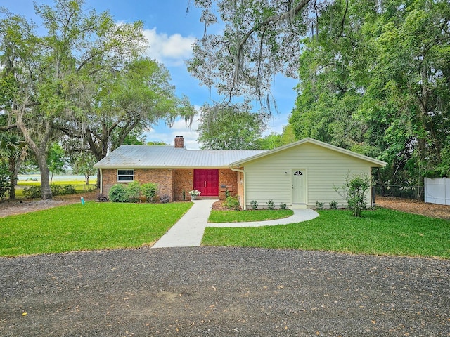 7972 State Rd Unit 100, Keystone Heights, FL 32656 - single story home featuring a chimney, a front yard, and metal roof