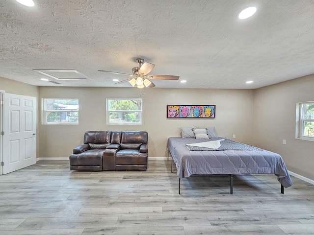 7972 State Rd Unit 100, Keystone Heights, FL 32656 - bedroom featuring baseboards, a textured ceiling, attic access, wood finished floors, and recessed lighting