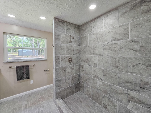 7972 State Rd Unit 100, Keystone Heights, FL 32656 - bathroom featuring baseboards, a tile shower, recessed lighting, and a textured ceiling