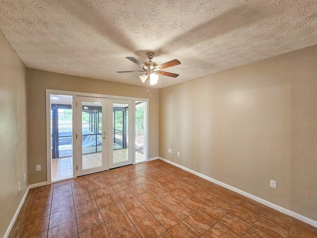 7972 State Rd Unit 100, Keystone Heights, FL 32656 - tiled empty room with french doors, a ceiling fan, baseboards, and a textured ceiling