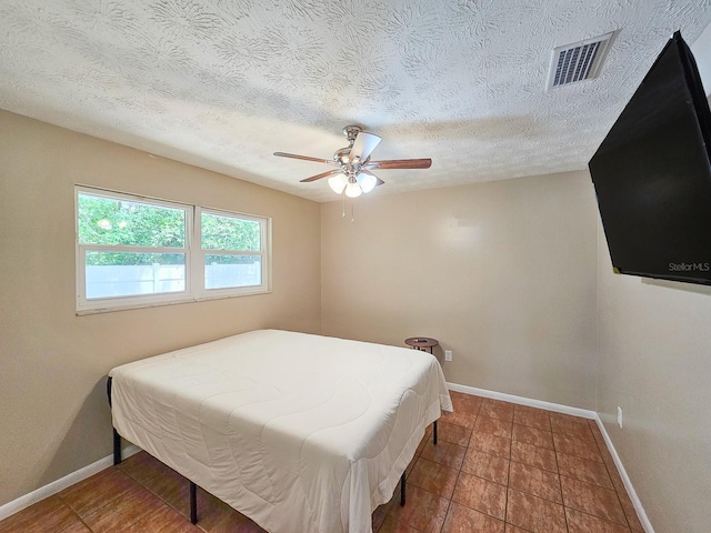7972 State Rd Unit 100, Keystone Heights, FL 32656 - bedroom featuring baseboards, a ceiling fan, and a textured ceiling