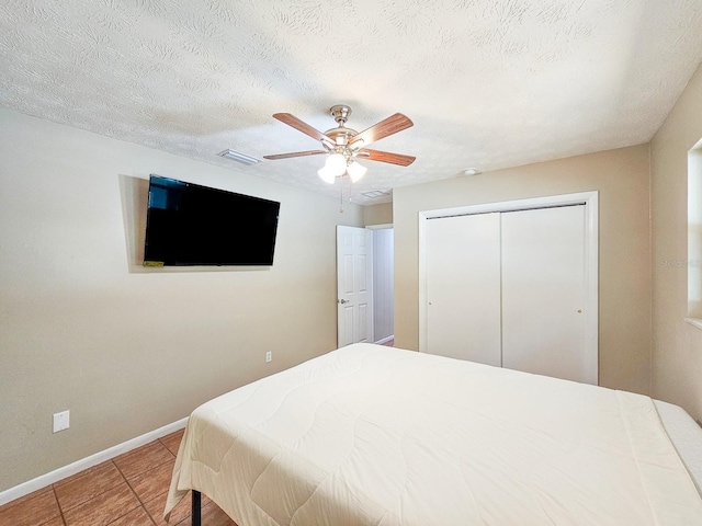 7972 State Rd Unit 100, Keystone Heights, FL 32656 - tiled bedroom featuring baseboards, a closet, ceiling fan, and a textured ceiling
