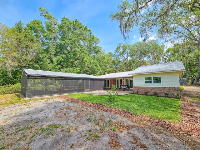 7972 State Rd Unit 100, Keystone Heights, FL 32656 - view of front of house with a patio, a chimney, brick siding, and a front lawn