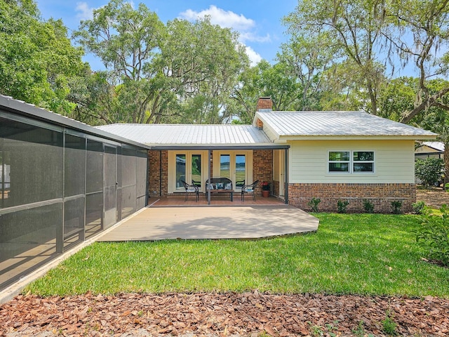 7972 State Rd Unit 100, Keystone Heights, FL 32656 - rear view of property featuring brick siding, a yard, a chimney, and metal roof