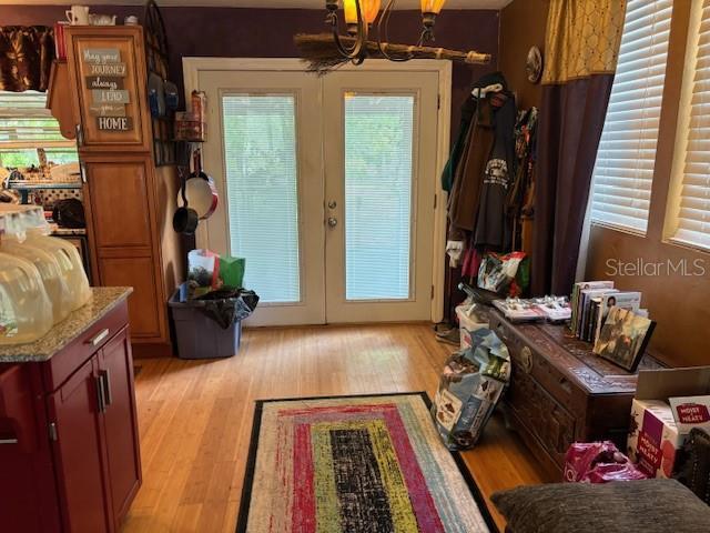 6410 SW 170th St, Archer, FL 32618 - entryway featuring french doors, a chandelier, and light wood-style flooring