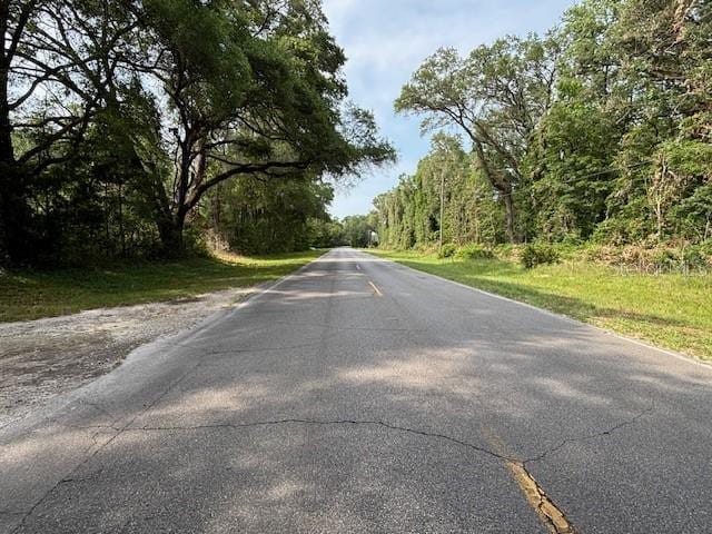 6410 SW 170th St, Archer, FL 32618 - view of asphalt street with a forest view