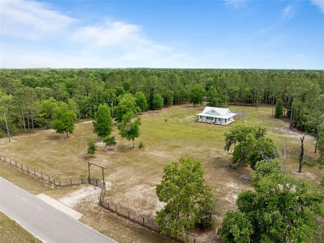 aerial view of sparsely populated area featuring a heavily wooded area