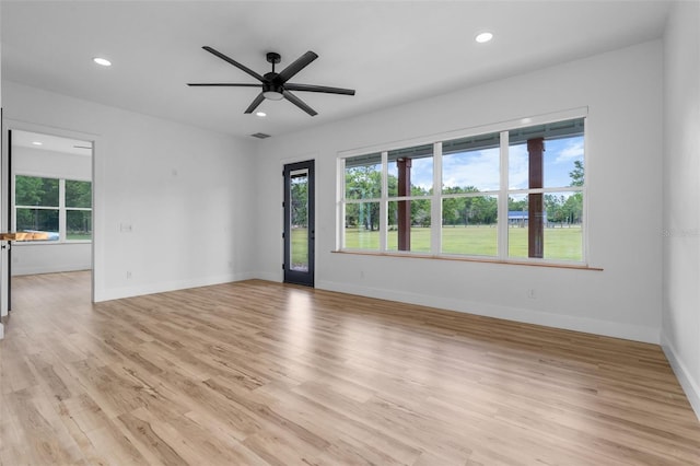 spare room featuring light wood-type flooring, recessed lighting, plenty of natural light, and a ceiling fan