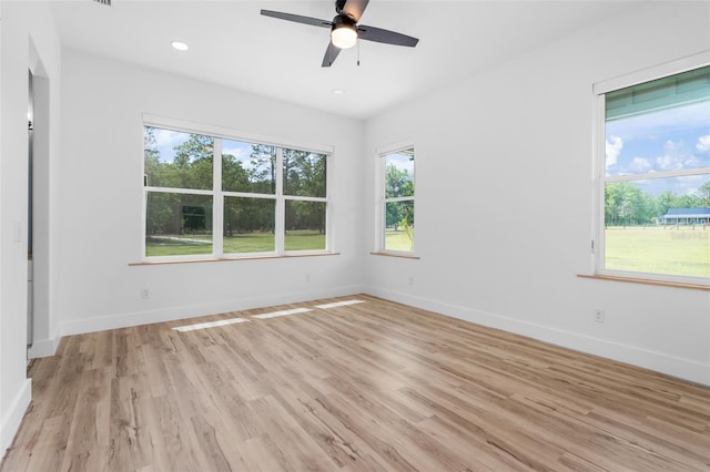 spare room with light wood-type flooring, baseboards, a ceiling fan, and recessed lighting