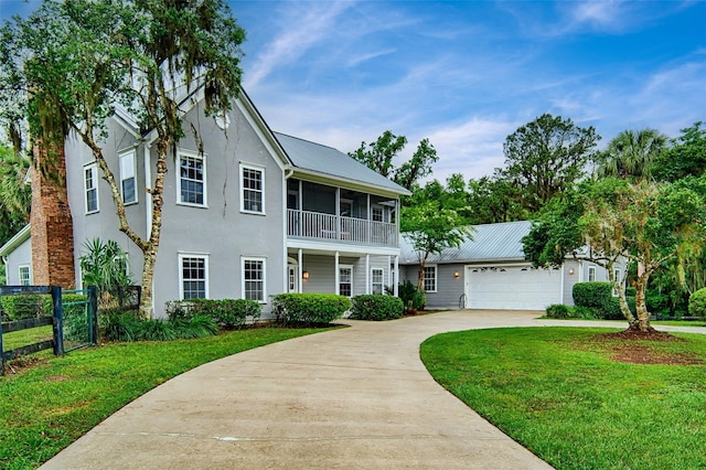 20250 NW 71st Ct, Micanopy, FL 32667 - view of front facade with driveway, stucco siding, a garage, and metal roof