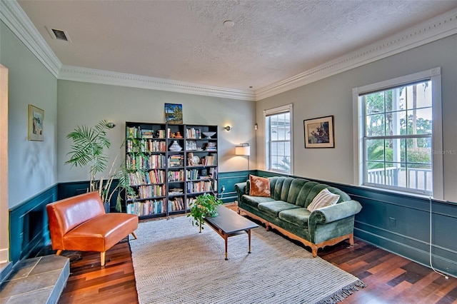 20250 NW 71st Ct, Micanopy, FL 32667 - living room with wood finished floors, ornamental molding, healthy amount of natural light, a wainscoted wall, and a textured ceiling