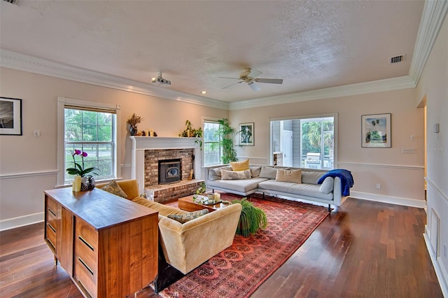 20250 NW 71st Ct, Micanopy, FL 32667 - living area with a ceiling fan, dark wood-style flooring, a brick fireplace, crown molding, and baseboards