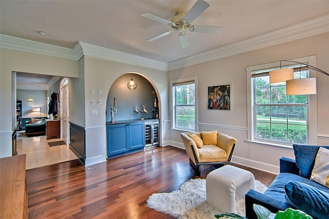 20250 NW 71st Ct, Micanopy, FL 32667 - sitting room featuring wine cooler, bar area, ornamental molding, dark wood-style flooring, and ceiling fan