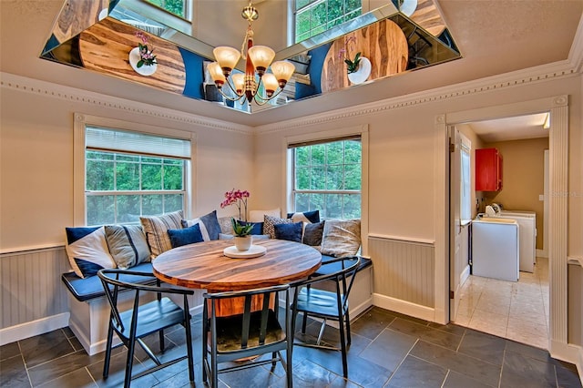 20250 NW 71st Ct, Micanopy, FL 32667 - dining room with washer / dryer, a wainscoted wall, a chandelier, breakfast area, and baseboards