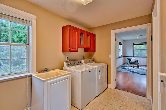 20250 NW 71st Ct, Micanopy, FL 32667 - clothes washing area with washing machine and dryer, cabinet space, baseboards, and light tile patterned floors