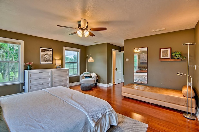 20250 NW 71st Ct, Micanopy, FL 32667 - bedroom featuring wood finished floors, baseboards, and a ceiling fan
