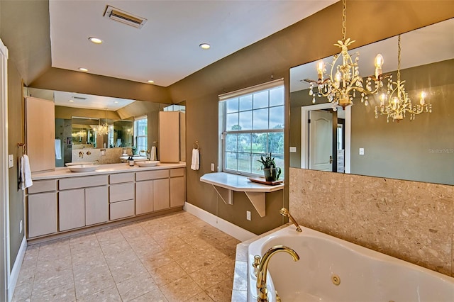 20250 NW 71st Ct, Micanopy, FL 32667 - bathroom featuring a chandelier, a tub with jets, baseboards, tile patterned flooring, and double vanity