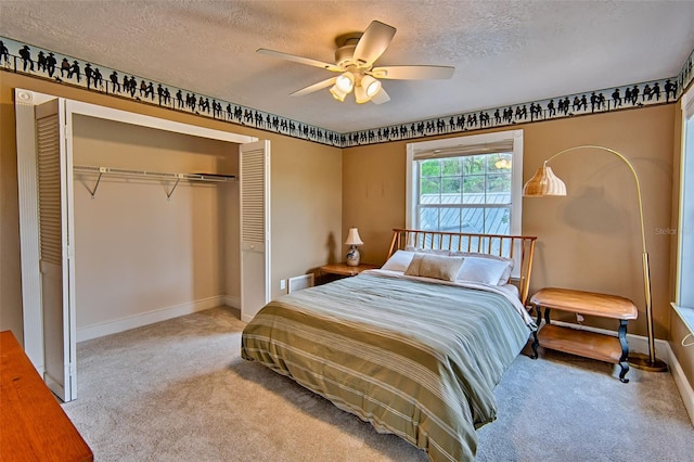 20250 NW 71st Ct, Micanopy, FL 32667 - carpeted bedroom with a closet, a textured ceiling, baseboards, and a ceiling fan