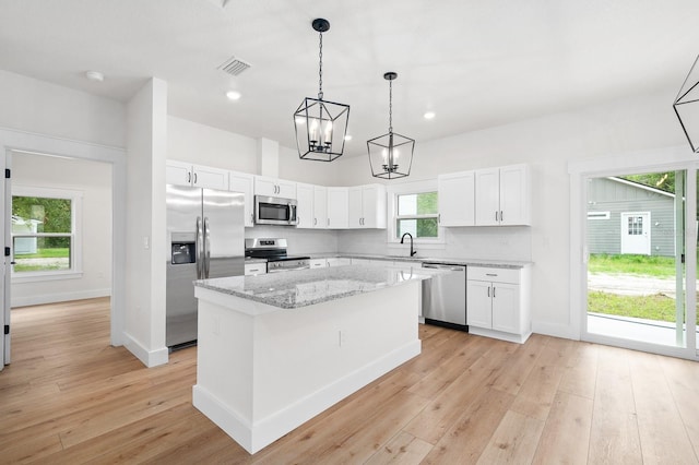3645 Frederick Ave, Bell, FL 32619 - kitchen with stainless steel appliances, a center island, light wood-style floors, white cabinetry, and recessed lighting