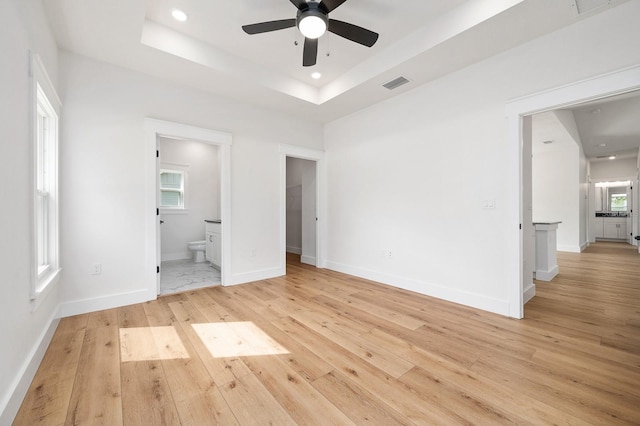 3645 Frederick Ave, Bell, FL 32619 - unfurnished bedroom with light wood-type flooring, recessed lighting, ensuite bathroom, baseboards, and a raised ceiling