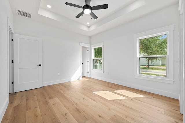 3645 Frederick Ave, Bell, FL 32619 - empty room featuring light wood-style floors, baseboards, a tray ceiling, a ceiling fan, and recessed lighting
