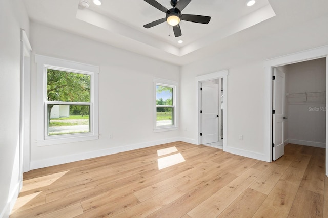 3645 Frederick Ave, Bell, FL 32619 - unfurnished bedroom featuring a tray ceiling, light wood-type flooring, recessed lighting, a spacious closet, and baseboards