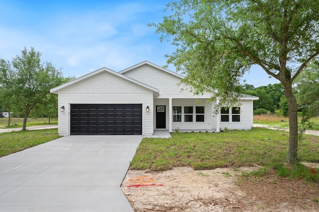 3645 Frederick Ave, Bell, FL 32619 - view of front facade with a garage, driveway, and a front yard